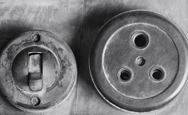 Close-up of an old lightswitch and a socket